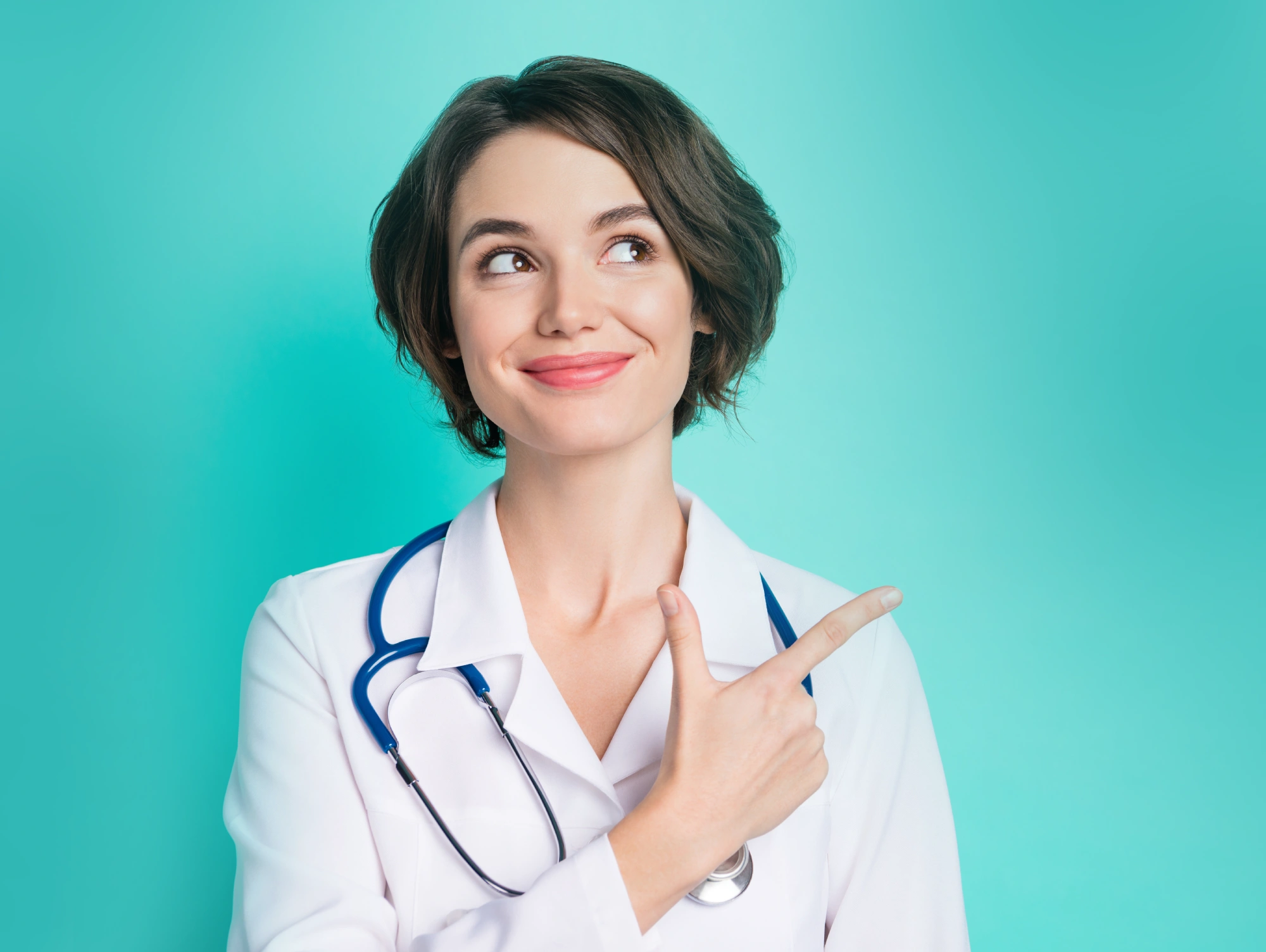 Smiling woman in a lab coat pointing, promoting blood draw services.